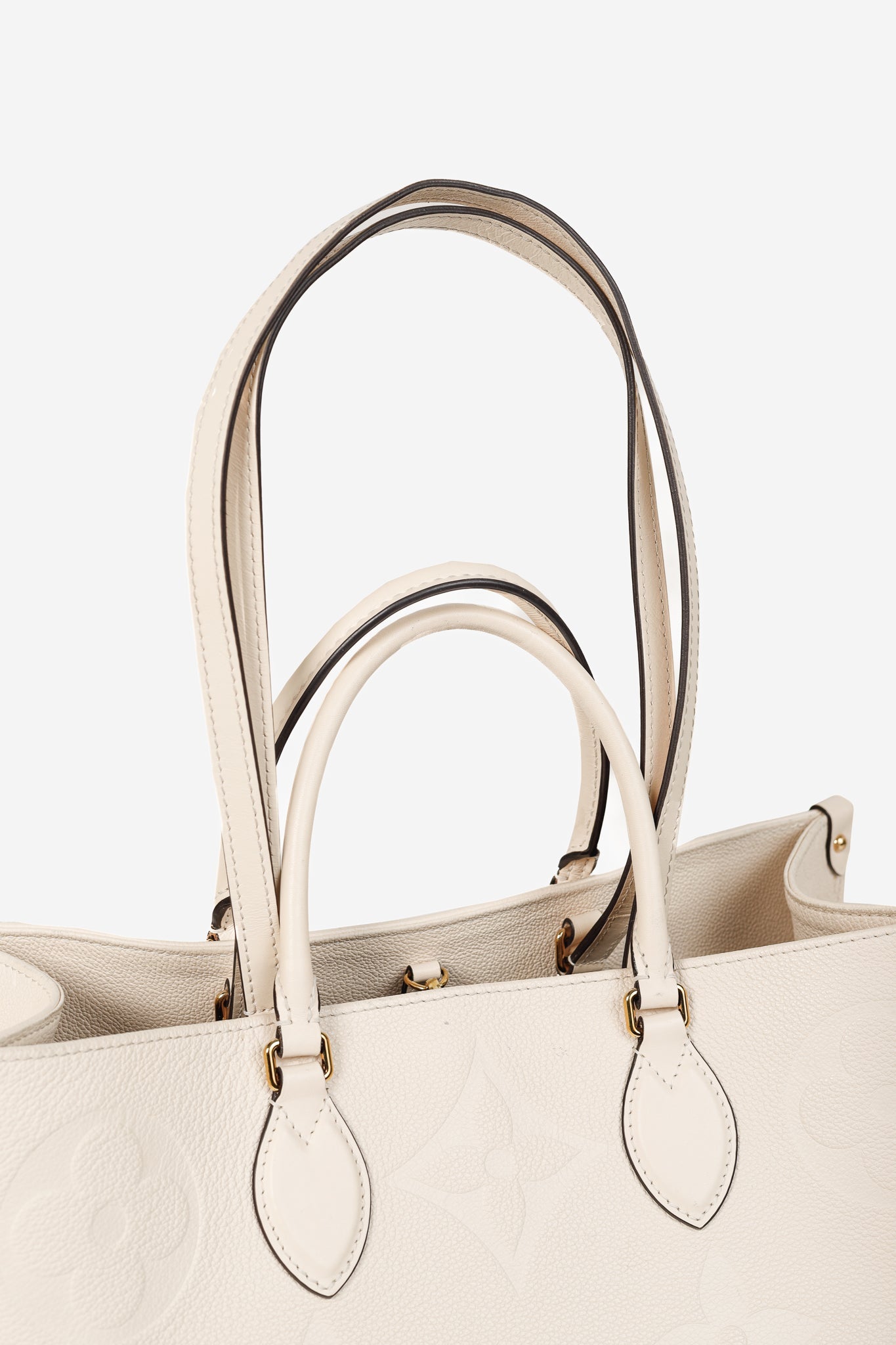 OnTheGo GM Creme Empreinte Monogram Leather Tote Bag