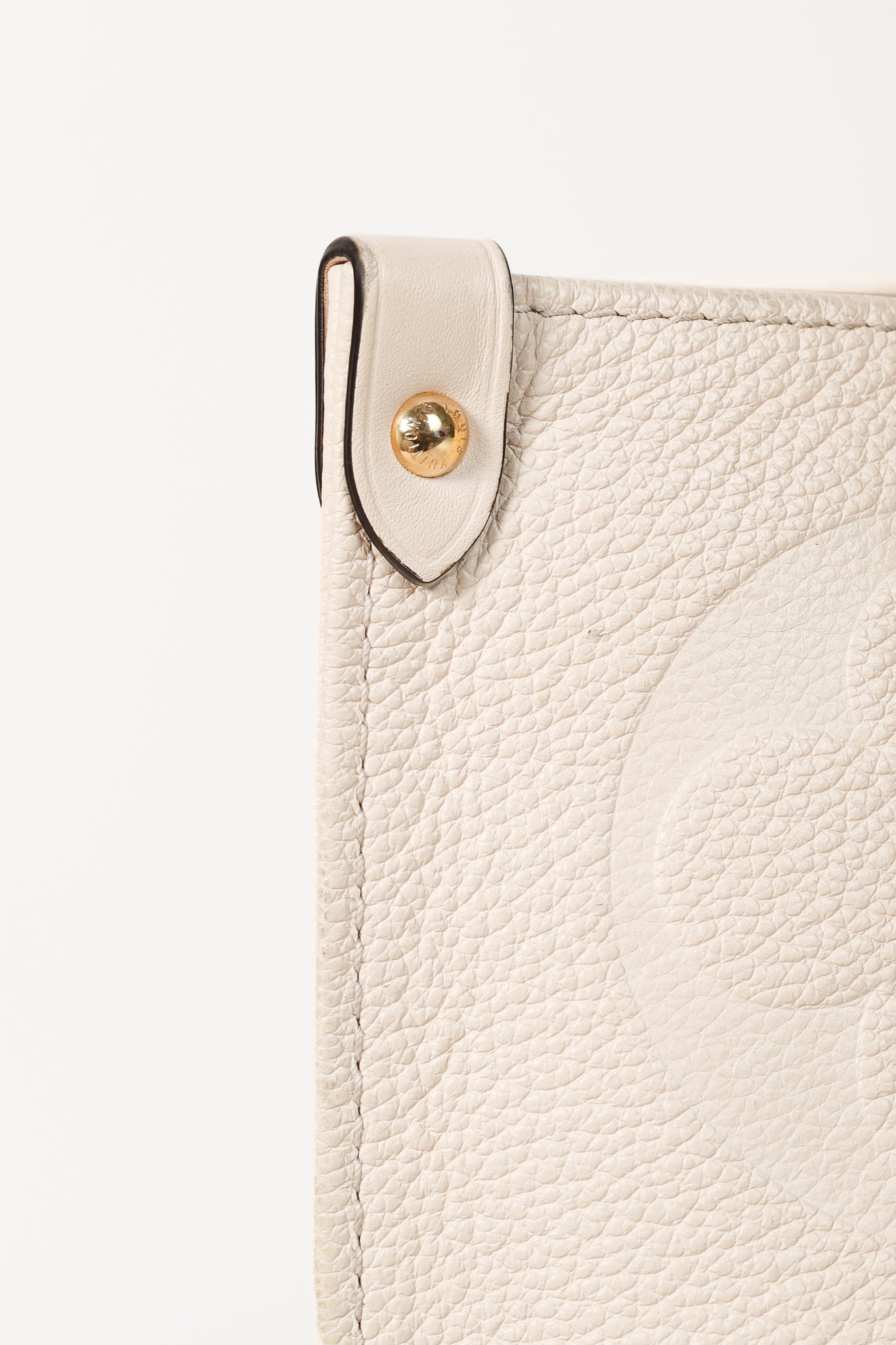 OnTheGo GM Creme Empreinte Monogram Leather Tote Bag