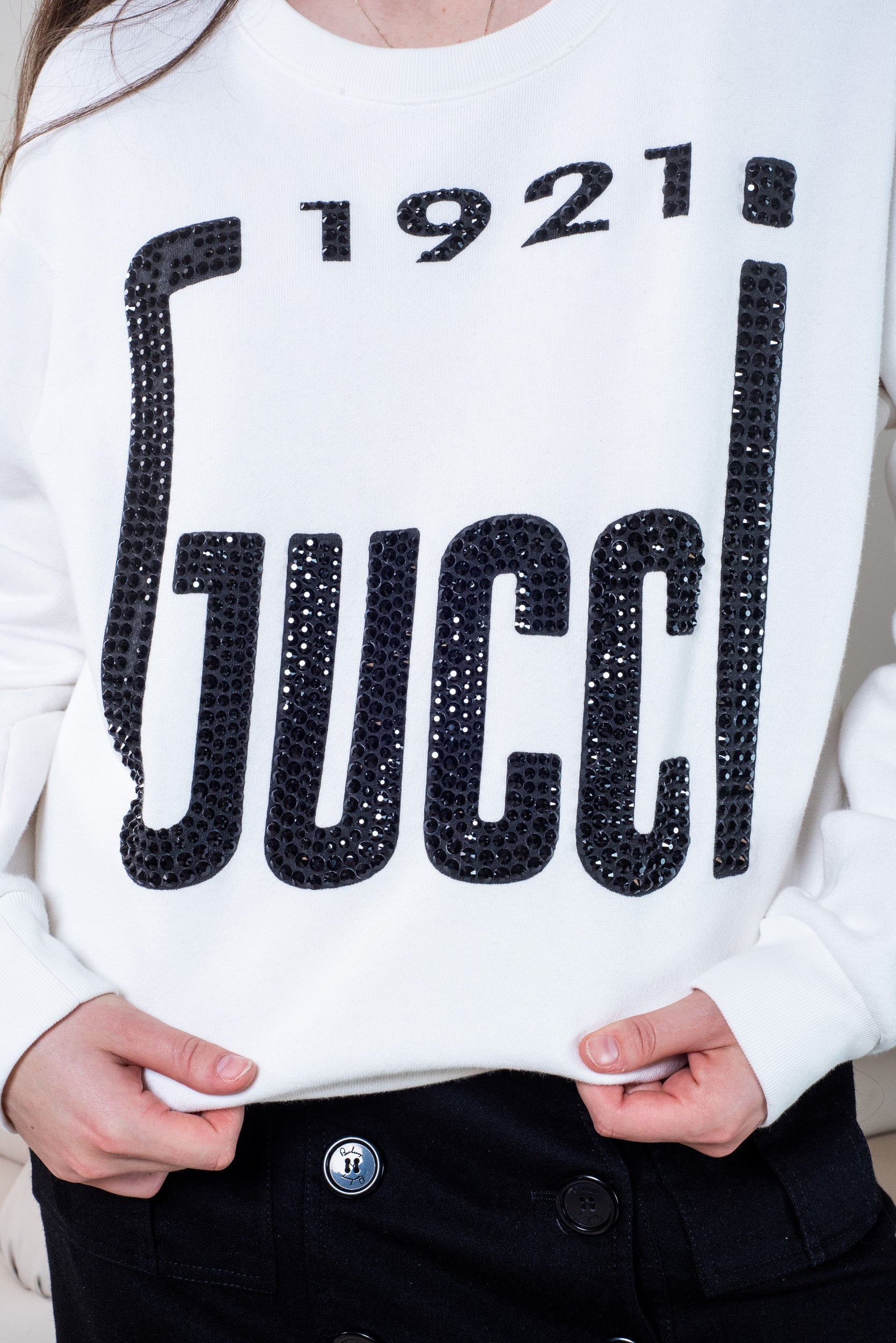 white logo black rhinestone sweater