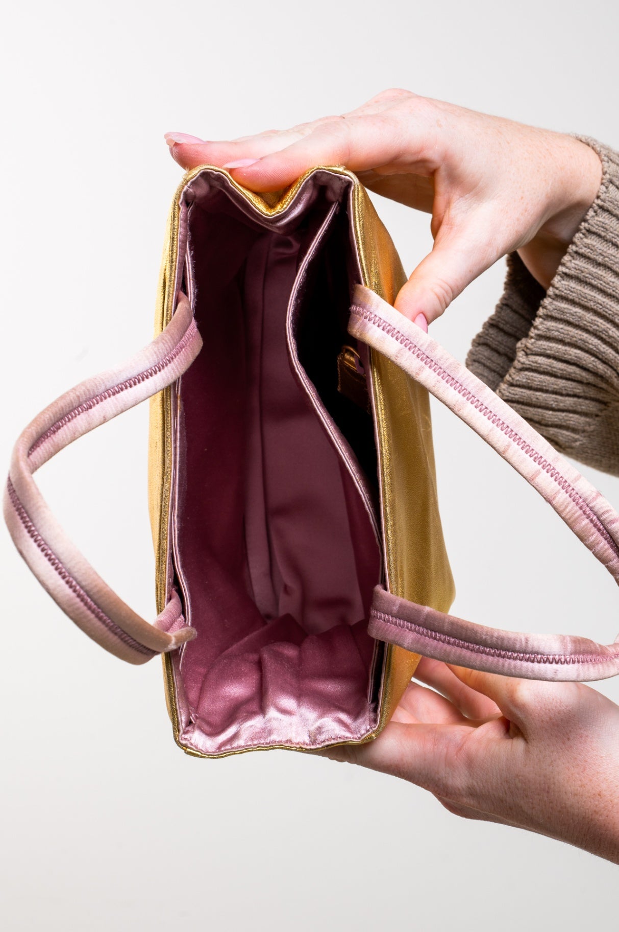 Gold embossed handbag with pink satin interior