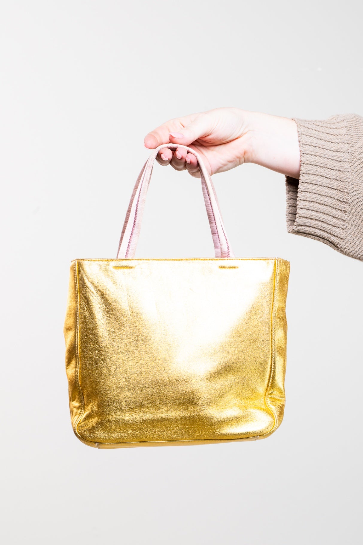 Gold embossed handbag with pink satin interior