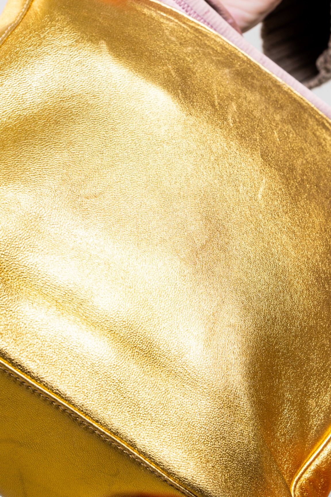 Gold embossed handbag with pink satin interior