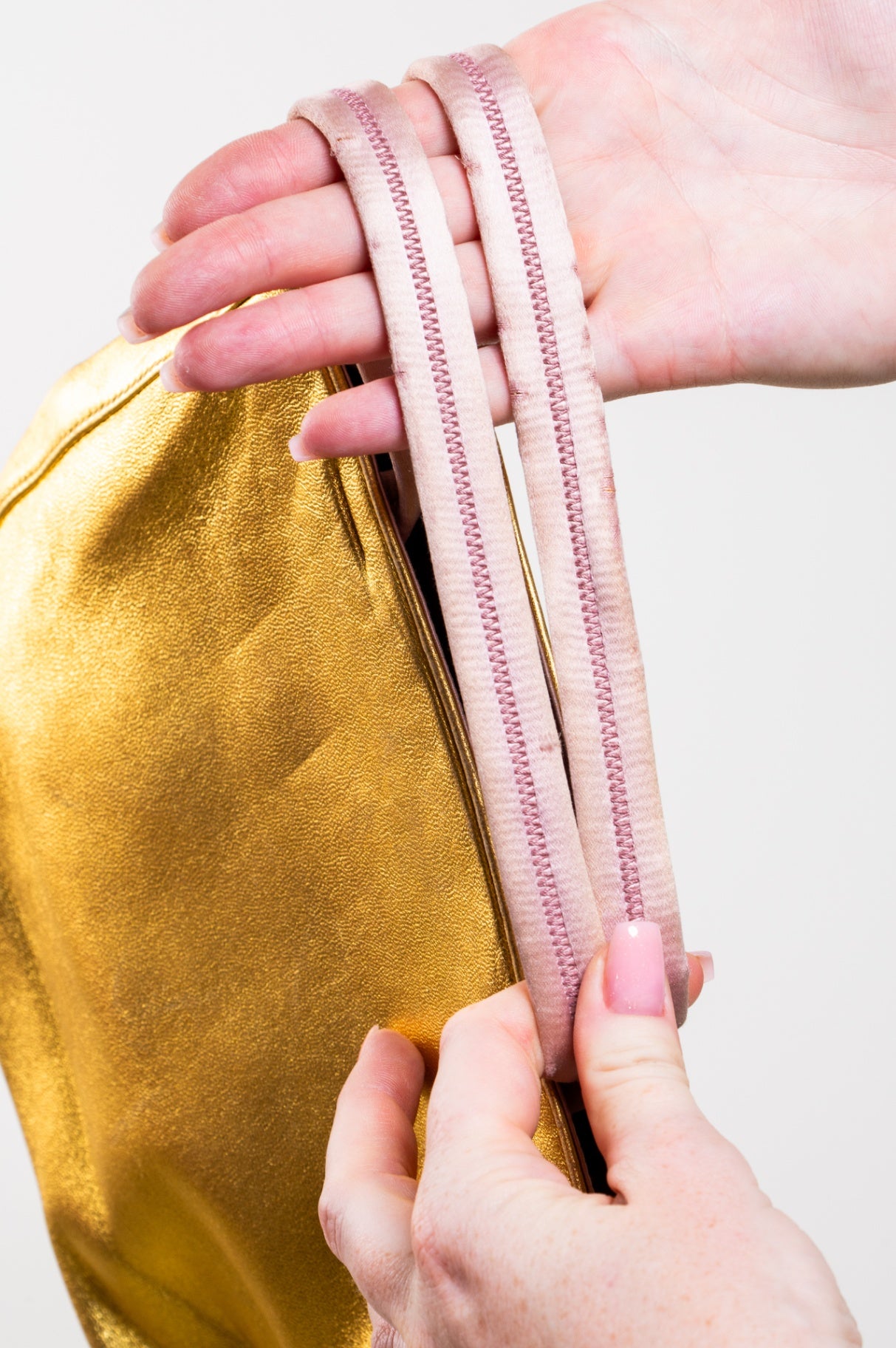 Gold embossed handbag with pink satin interior