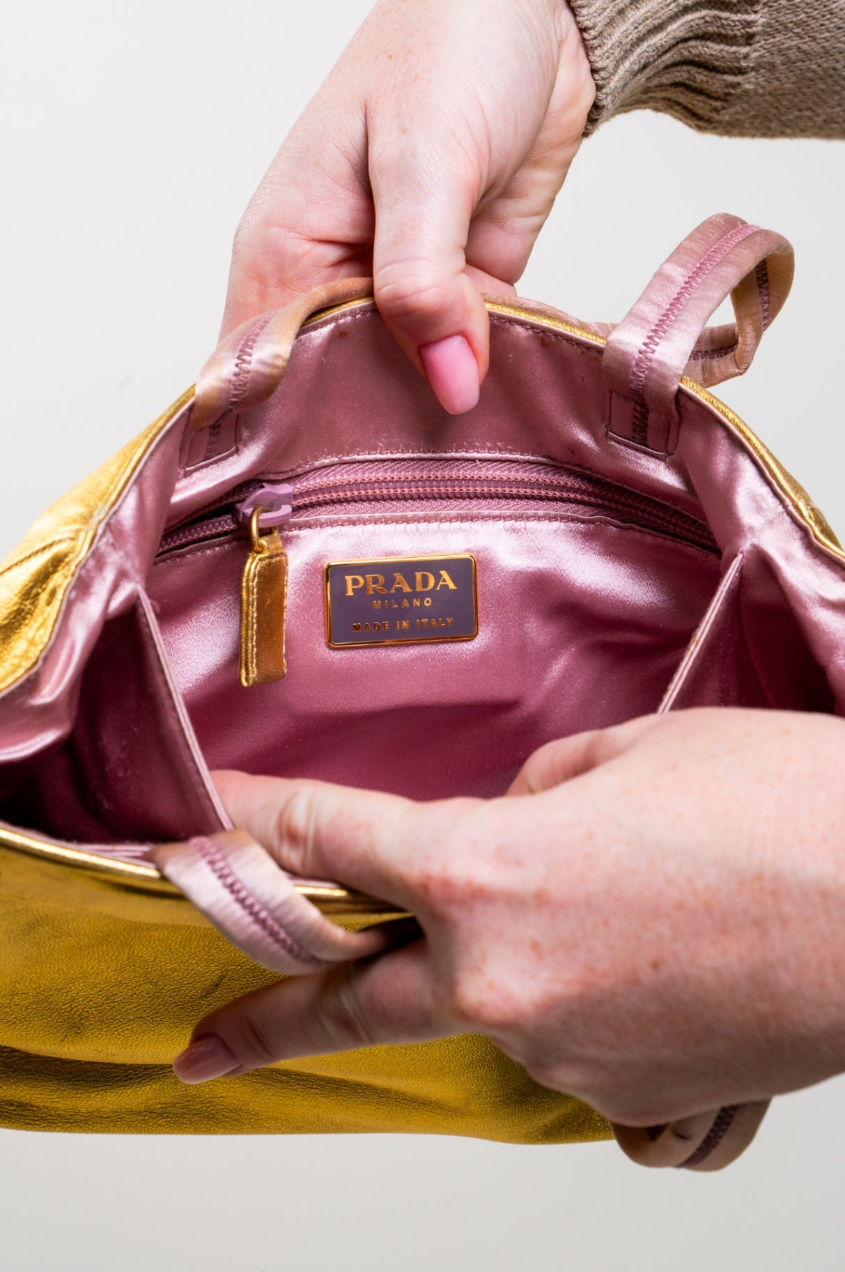 Gold embossed handbag with pink satin interior