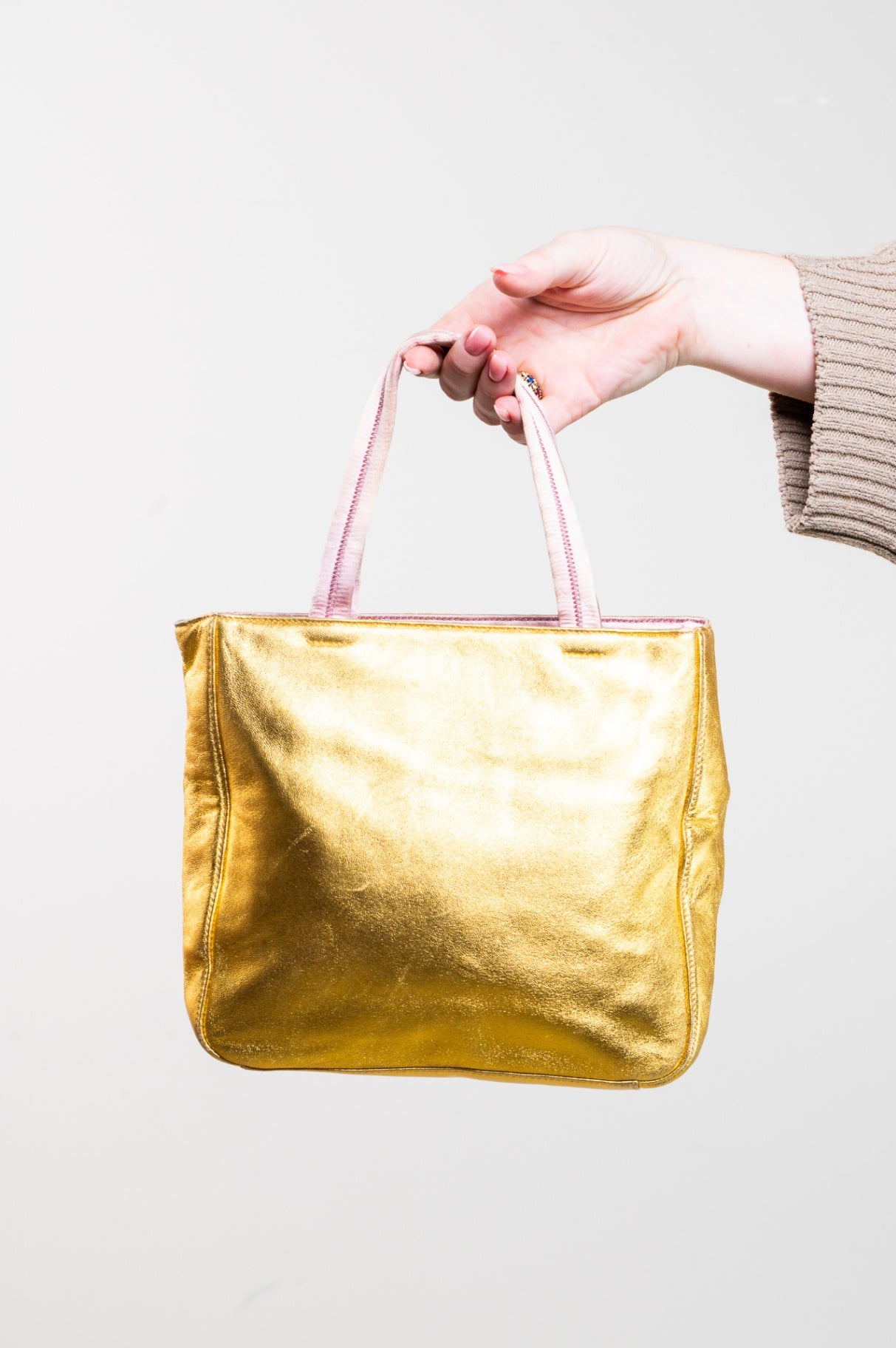 Gold embossed handbag with pink satin interior
