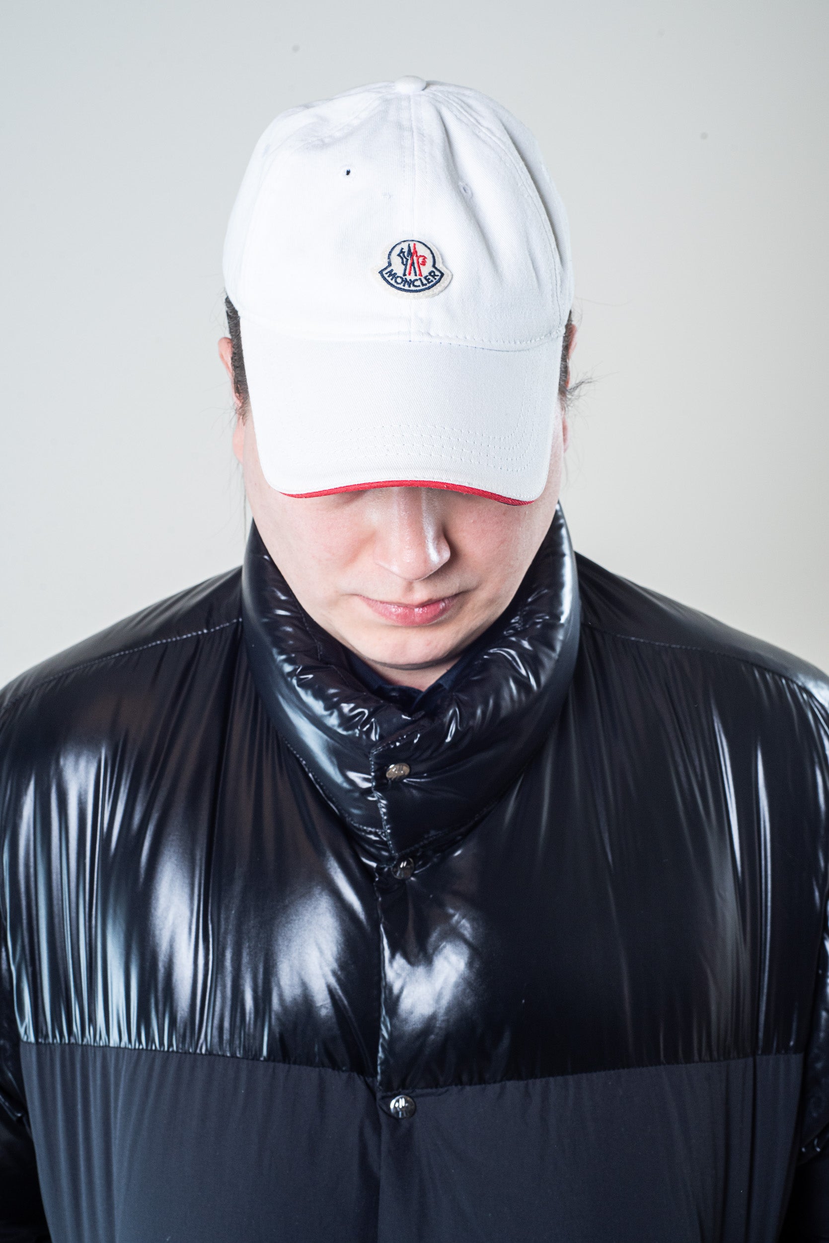 Front view of Moncler white logo ball cap worn by model