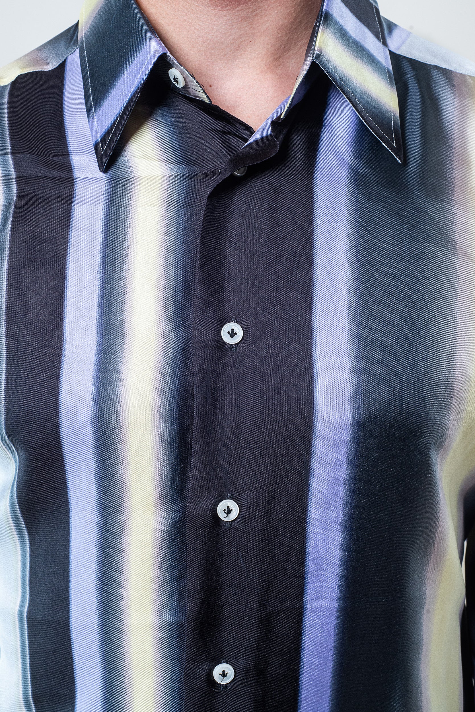Close-up of silk fabric and vibrant stripe pattern on Versace shirt
