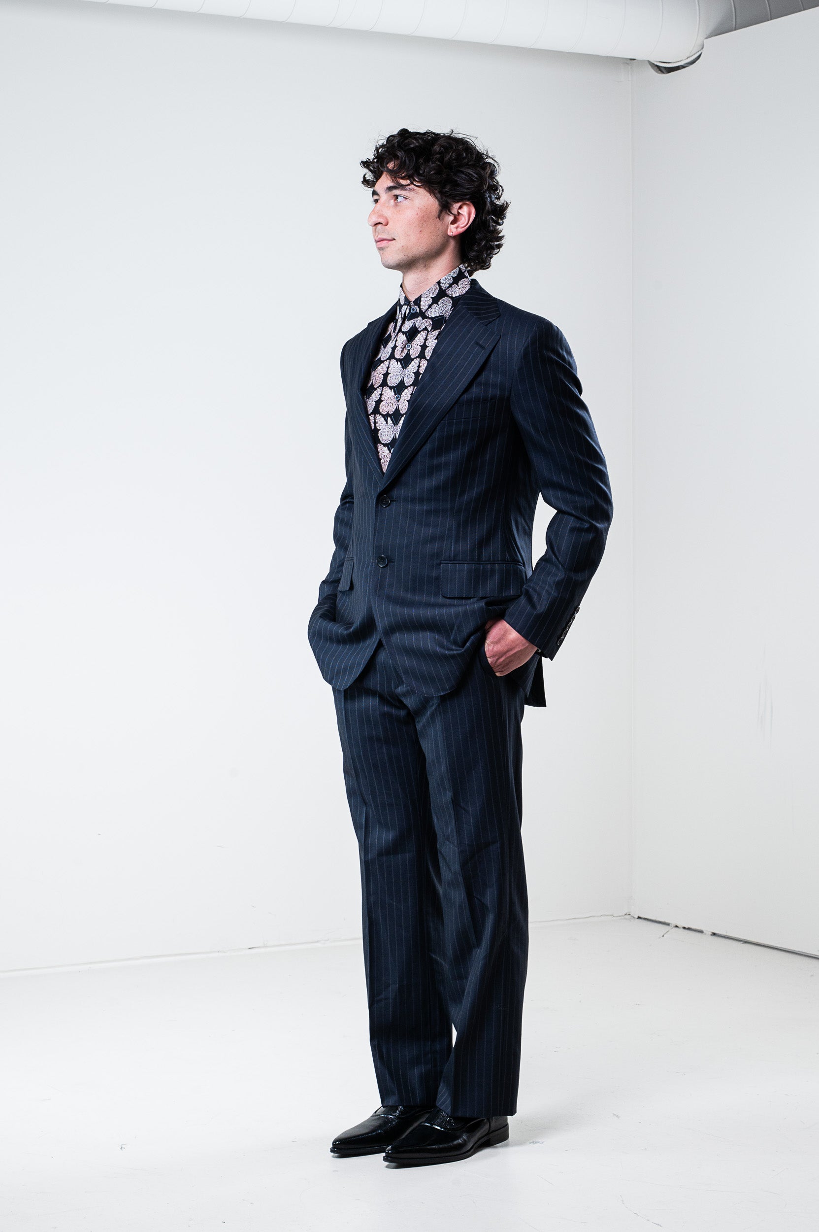 Model wearing Gucci silk butterfly shirt - side view