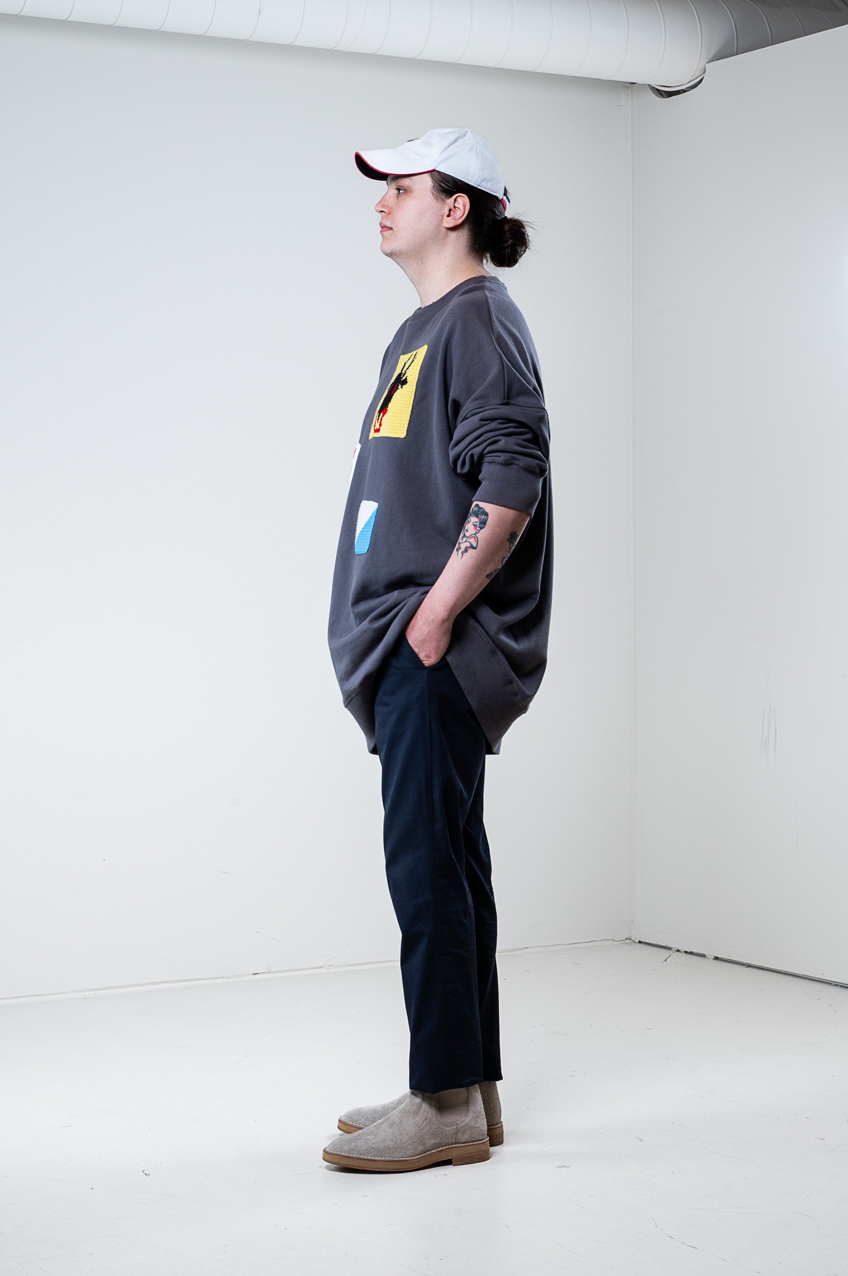 Side view of J.W. Anderson Grey Patch Knit Crew Neck Sweater