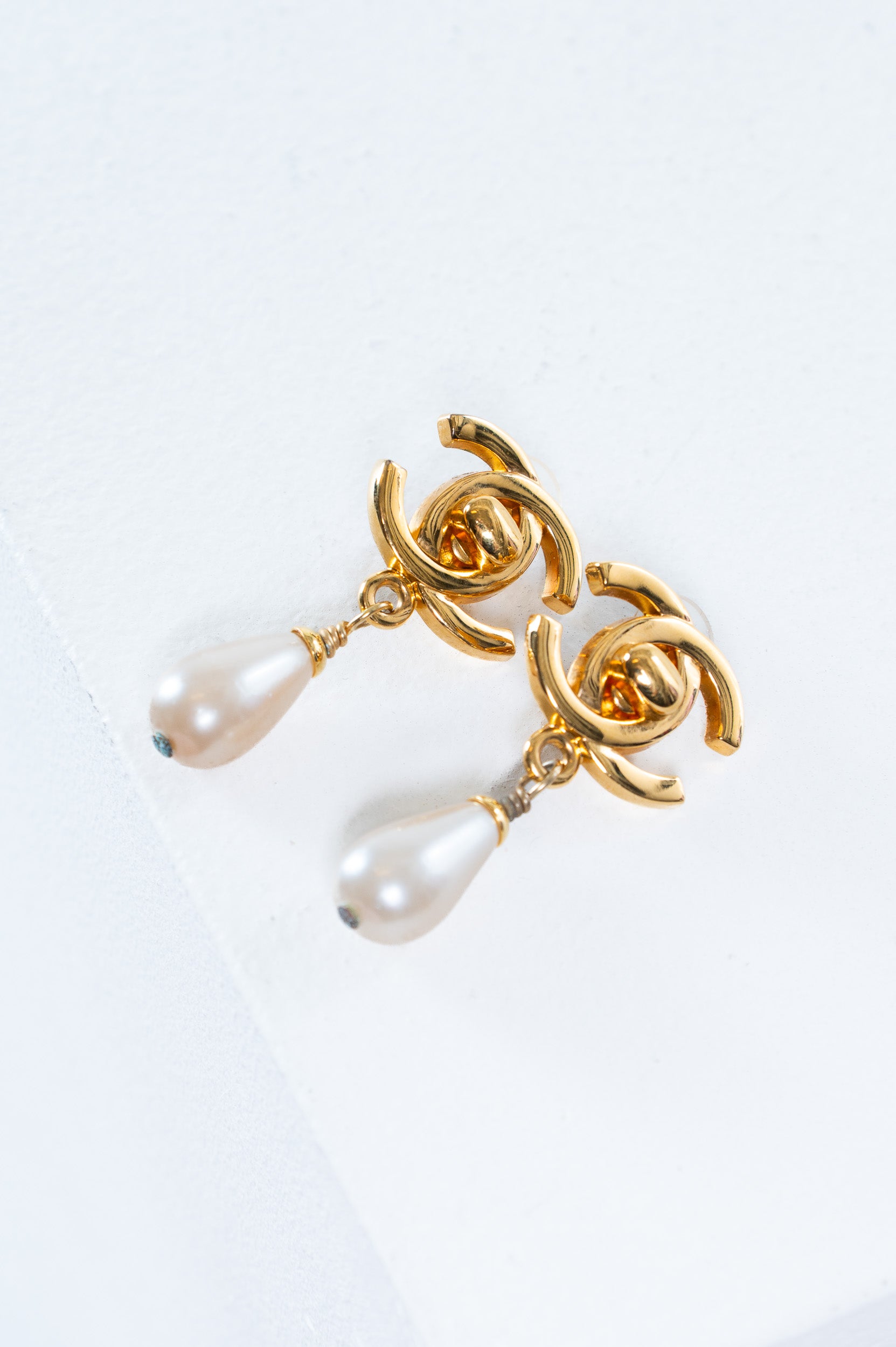 Front view of Chanel Vintage CC Turnlock Pearl Drop Clip On Earrings showing gold hardware and pearl detail