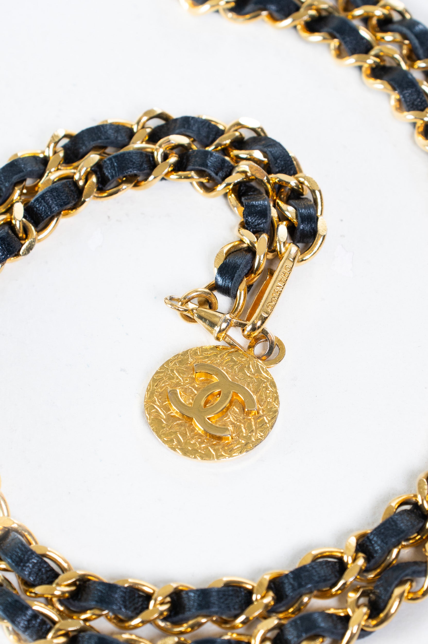 Detailed close-up of the gold-tone medallion