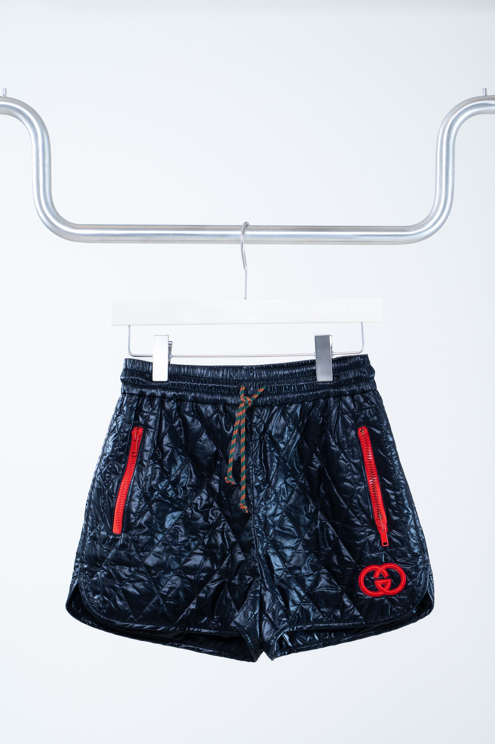 Front view of Gucci Quilted Black GG Shorts with red contrast detail