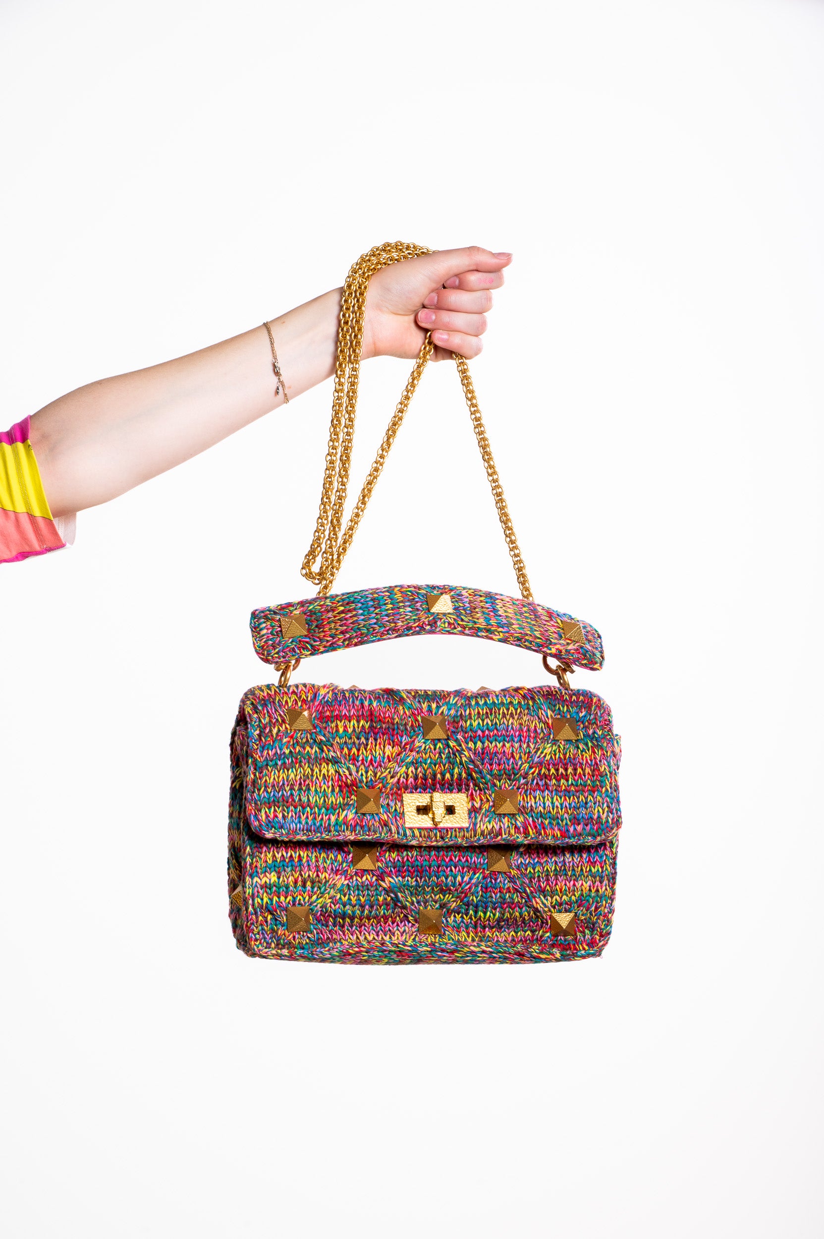 Valentino Garavani Roman Stud Medium Quilted Shoulder Bag being carried by hand