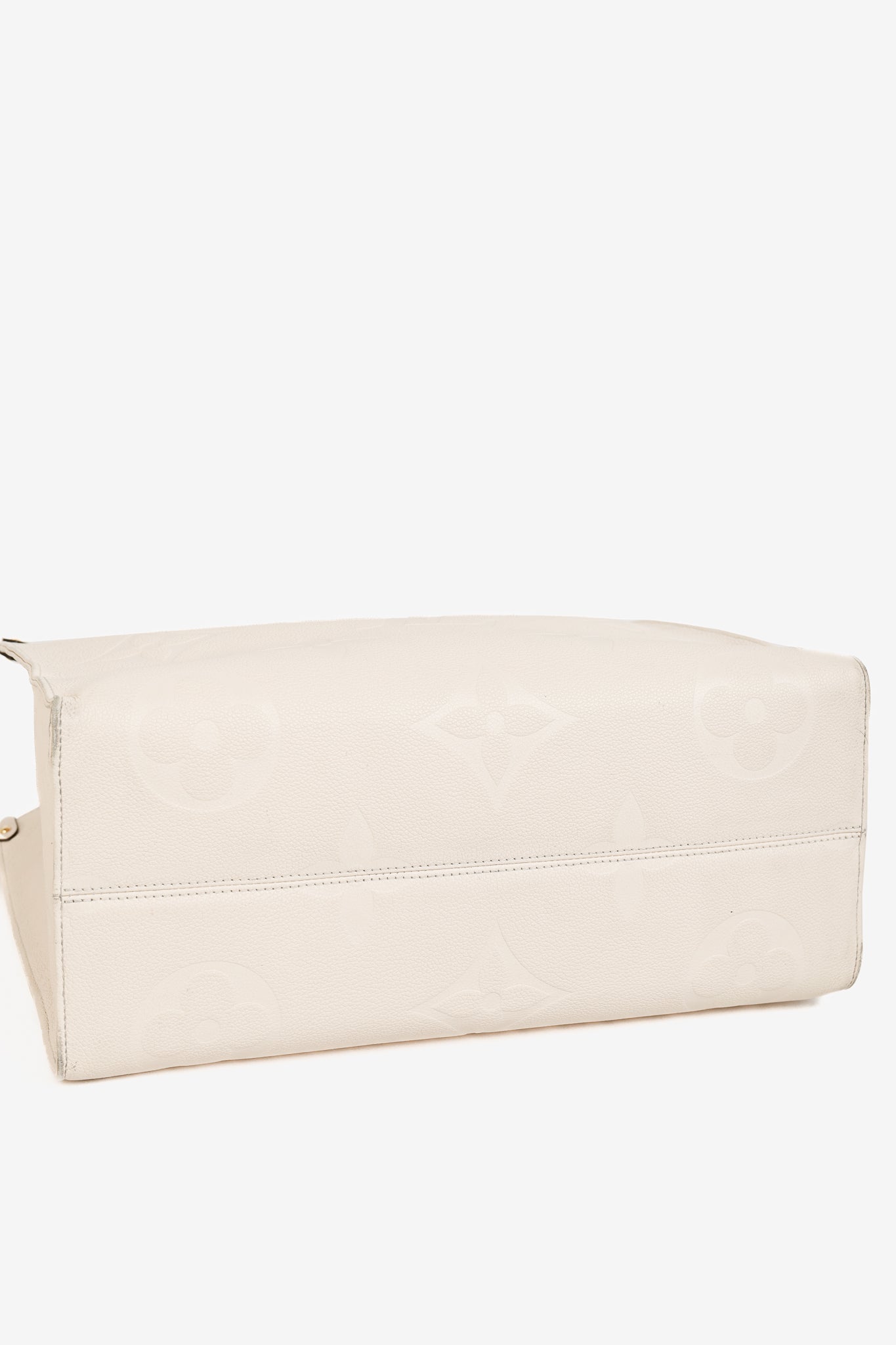 OnTheGo GM Creme Empreinte Monogram Leather Tote Bag