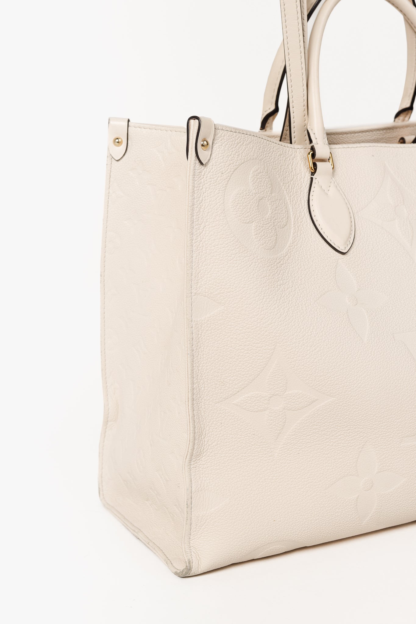 OnTheGo GM Creme Empreinte Monogram Leather Tote Bag