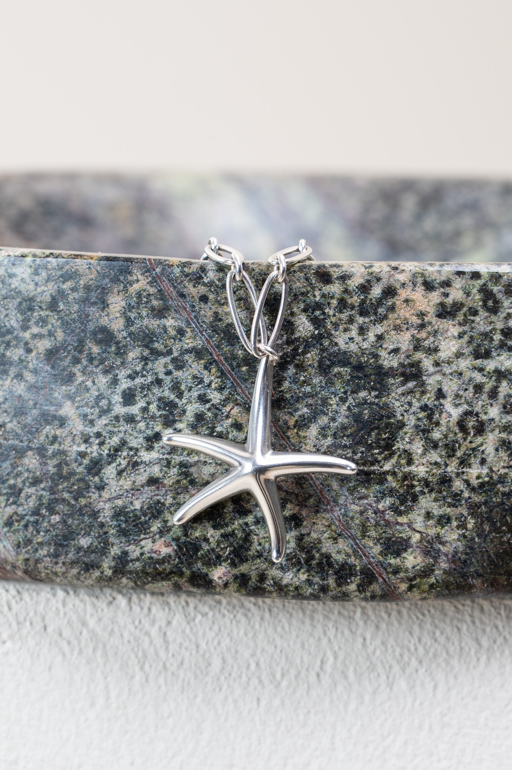 Close-up of starfish pendant texture on Tiffany sterling silver necklace