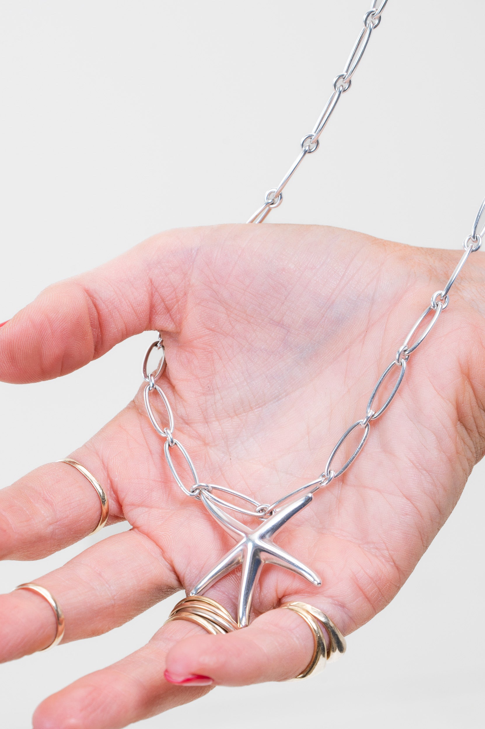Close-up view of Tiffany & Co. Starfish Pendant on Paperclip Chain