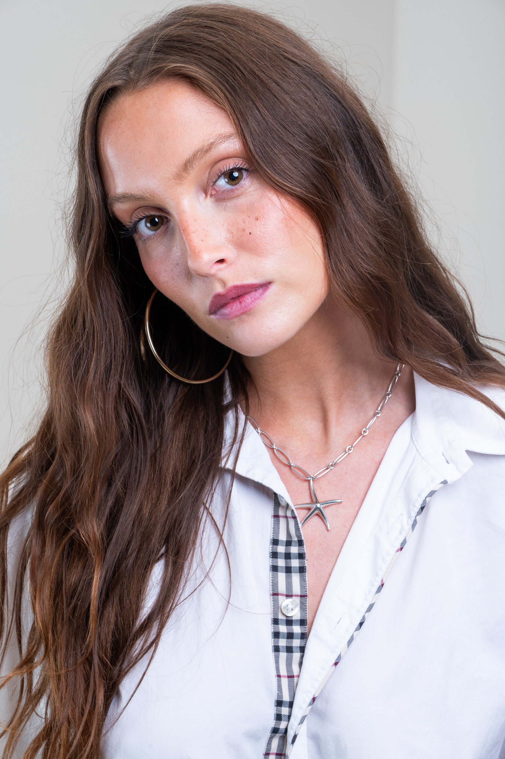 Tiffany & Co. Starfish Pendant on Paperclip Chain styled on model’s neckline