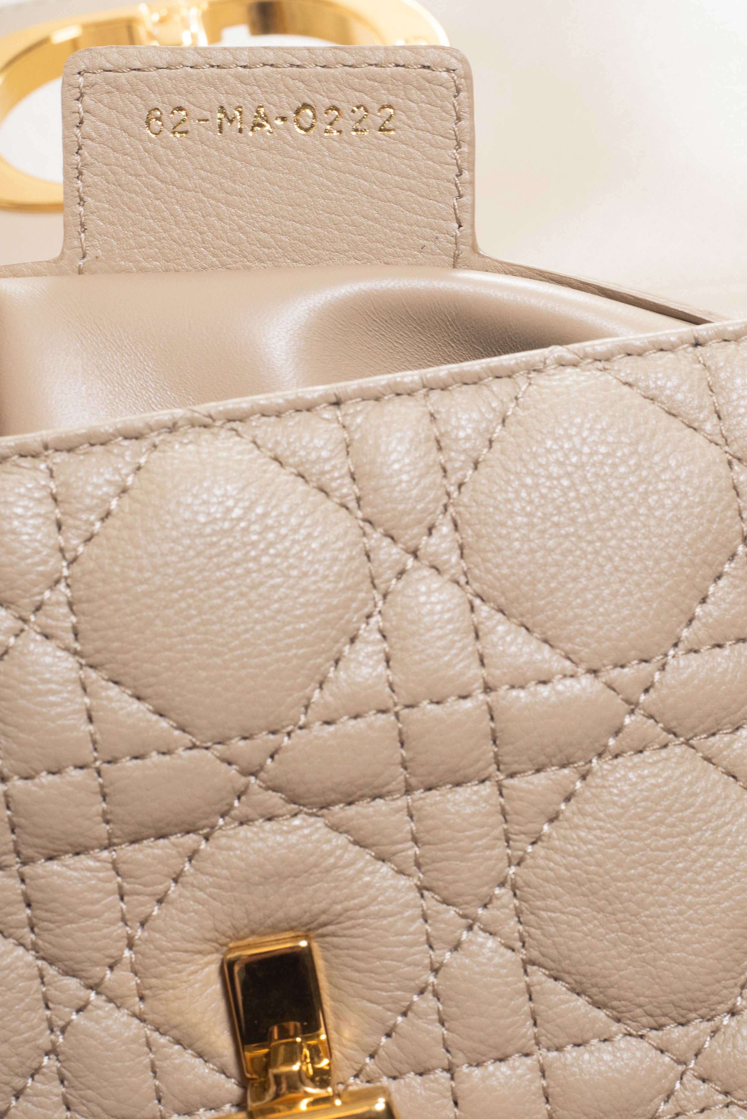Detailed view of the soft beige calfskin leather texture on the Christian Dior Small Beige Cannage Calfskin Caro Bag