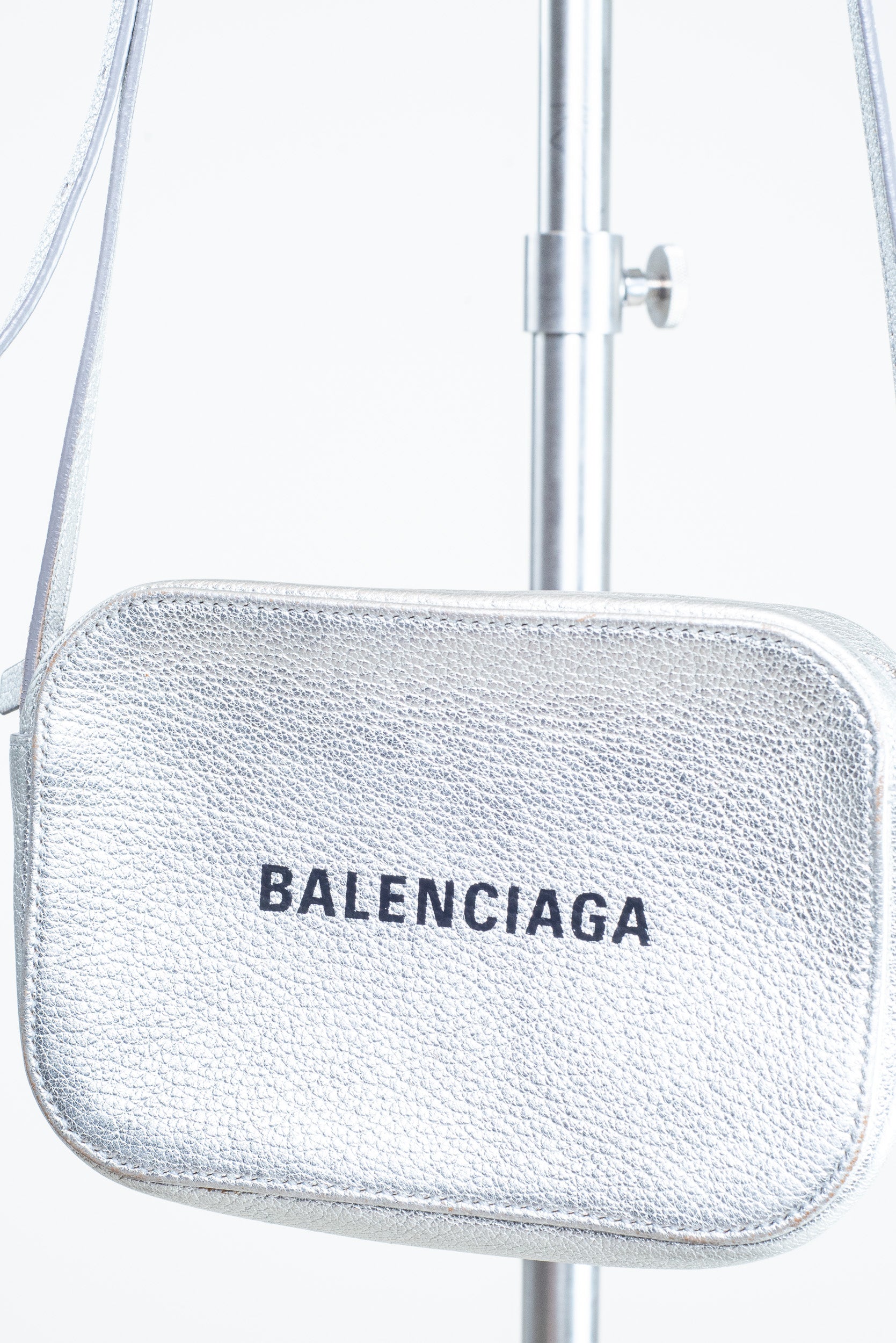 Close-up front view of the Balenciaga Everyday Crossbody Bag in silver leather with black logo
