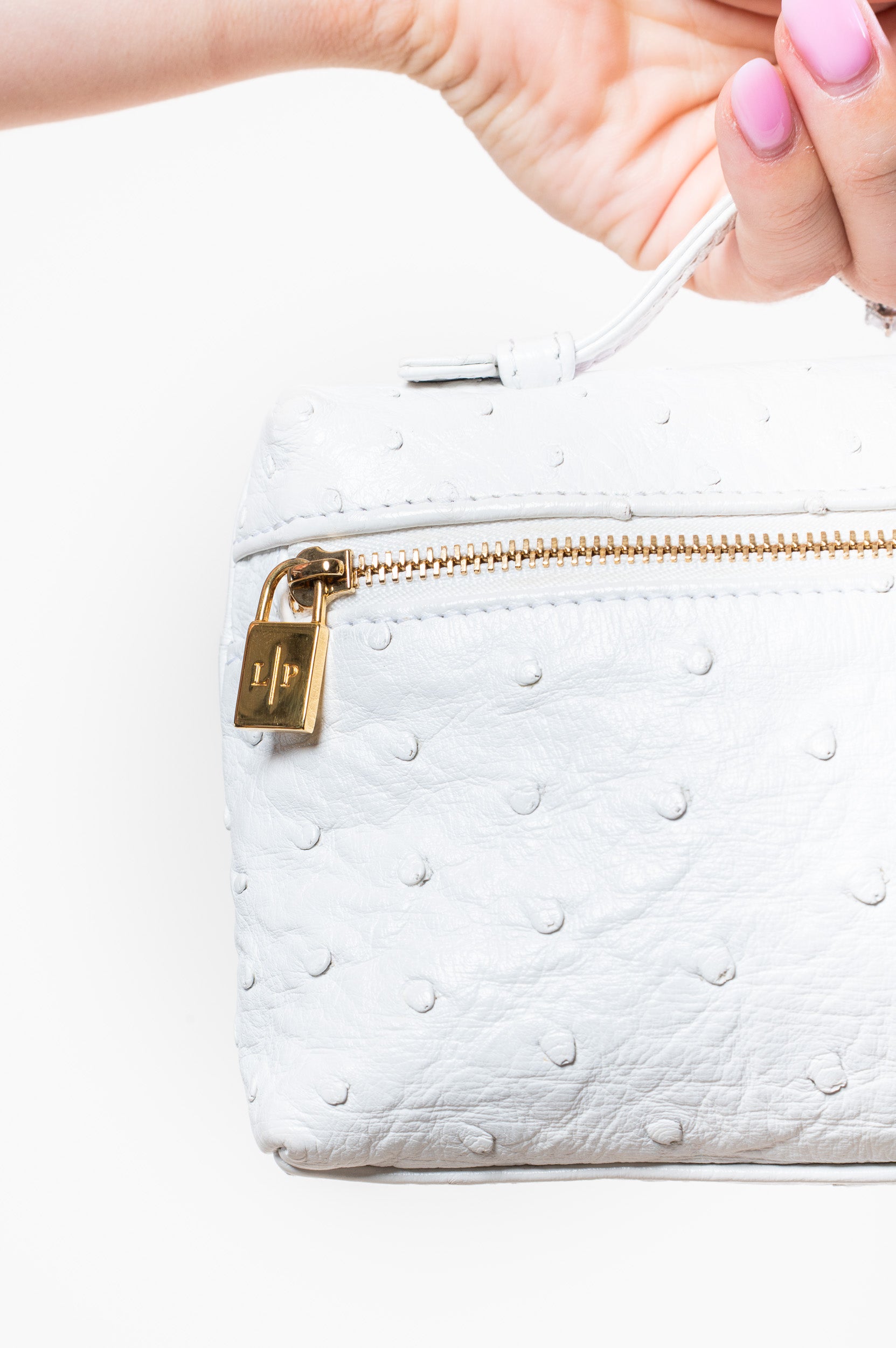 Close-up view of Loro Piana White Ostrich Top Handle Zip Bag
