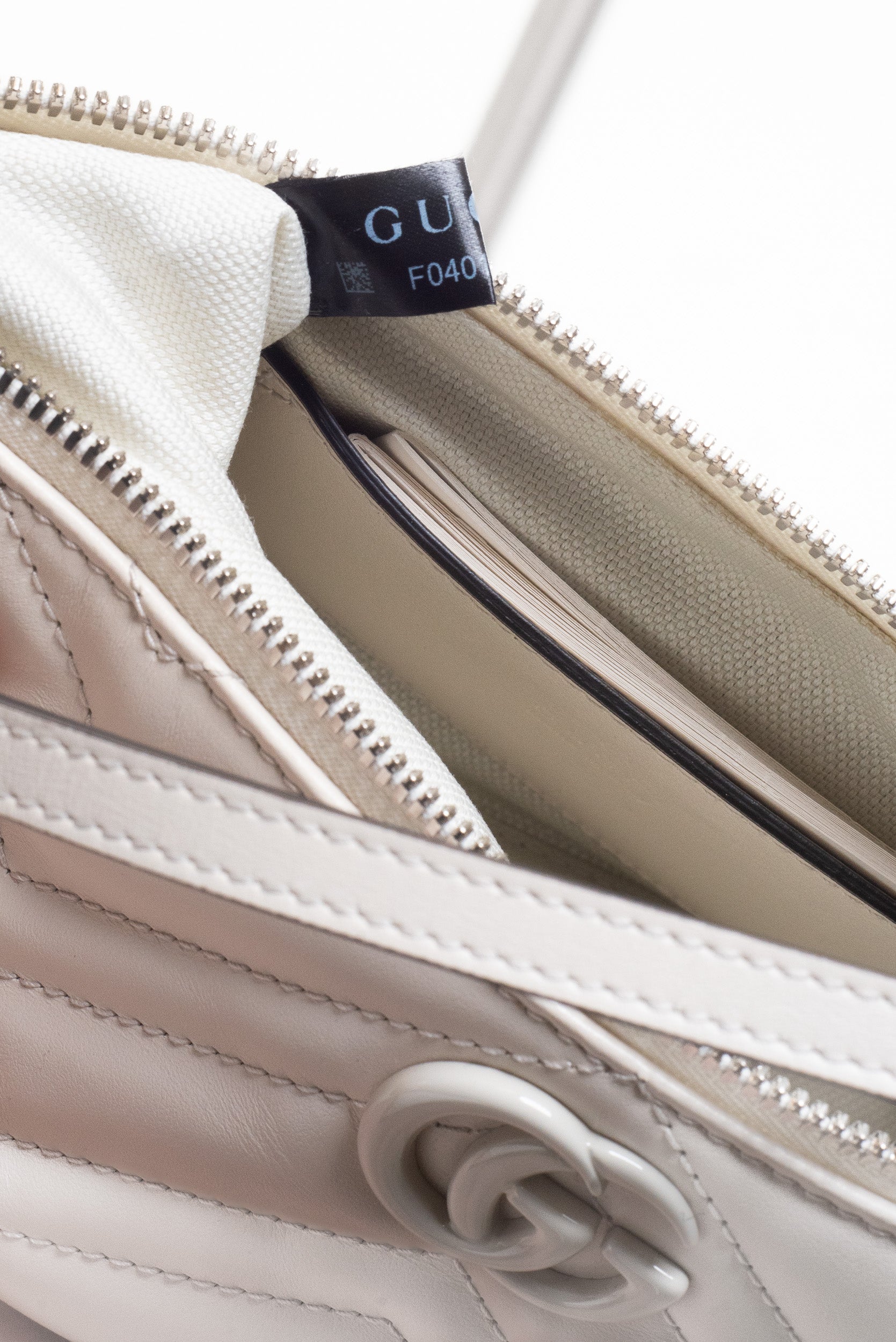 Close-up of zipper detail on Gucci Mystic White GG Marmont Leather Chevron Shoulder Bag