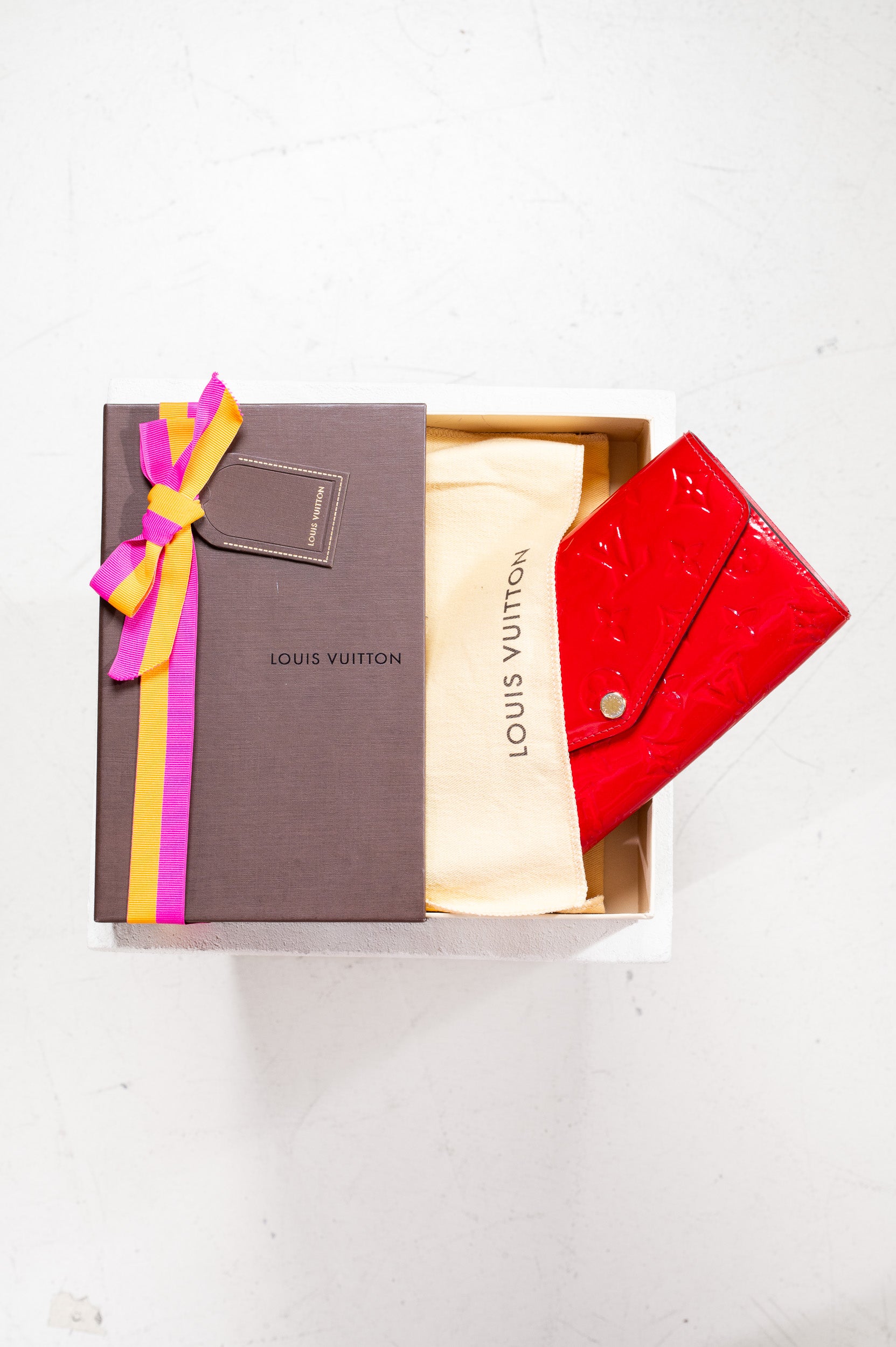 Dust bag and original box of Louis Vuitton Red Monogram Sarah Wallet