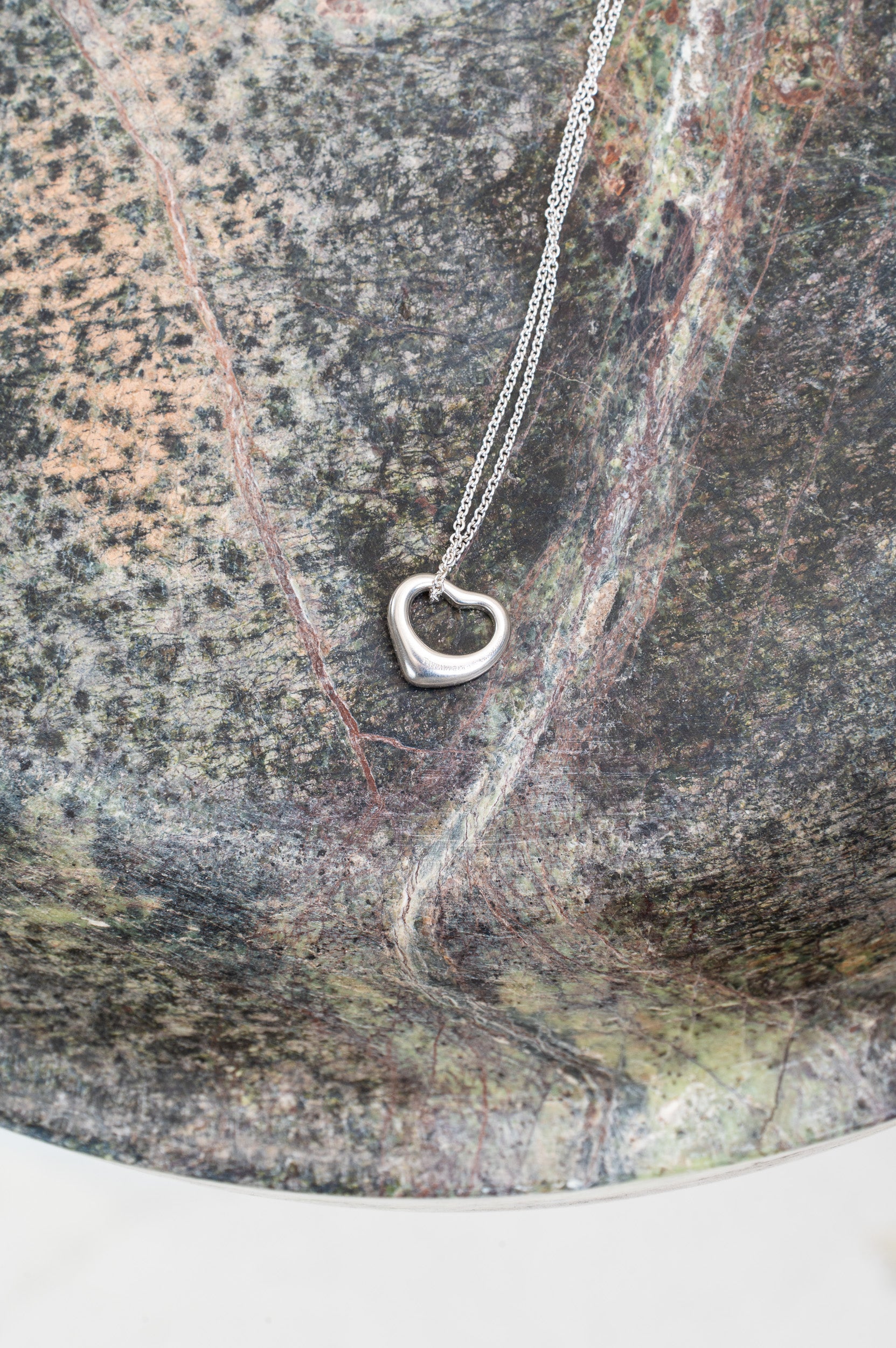 Another view of open heart pendant on Tiffany & Co. necklace