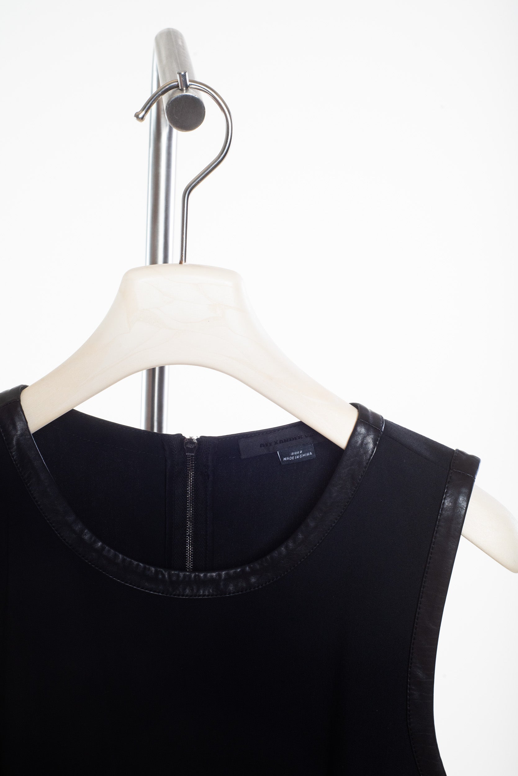 Black Sleeveless Dress with Pleated Skirt and Leather Trim