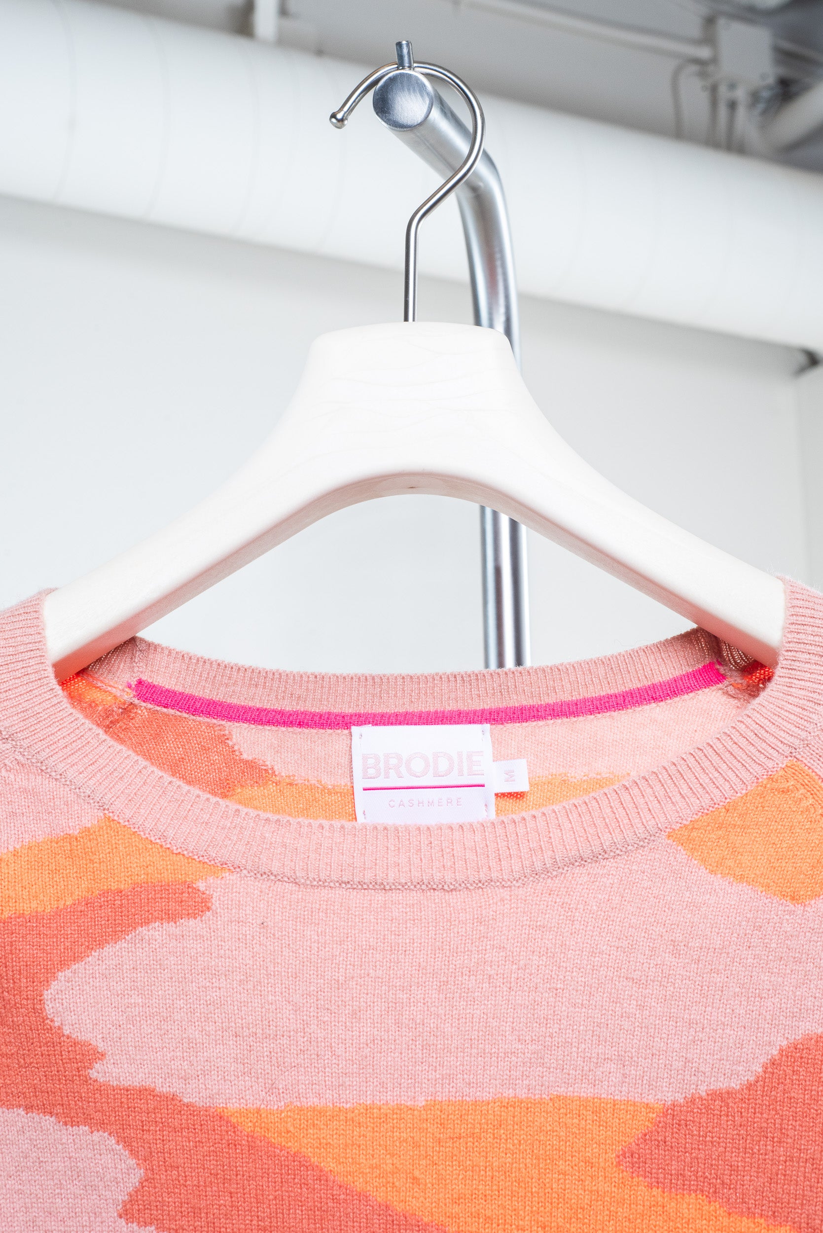 Close-up view of Brodie Cashmere Orange Camouflage Sweater