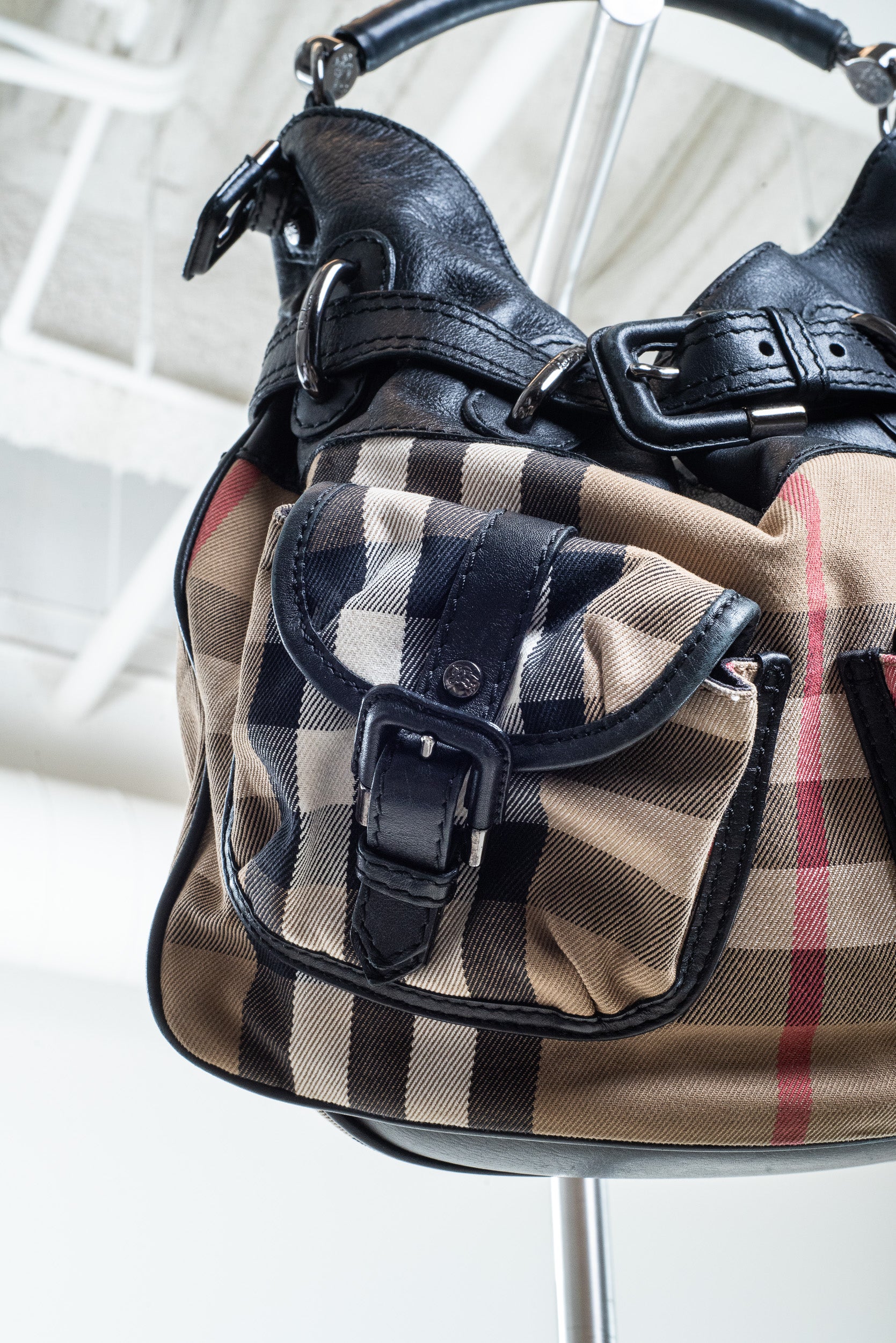 Close-up of Burberry check pattern on canvas bag