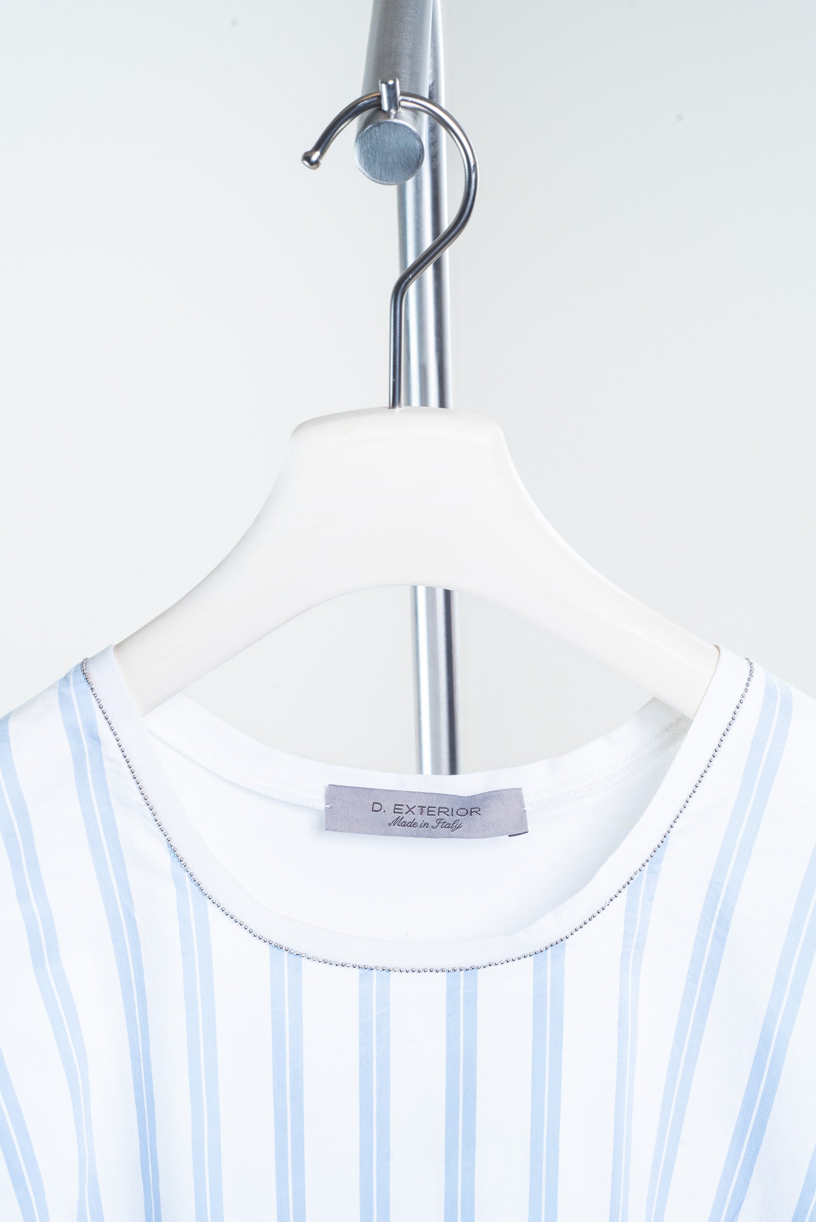 Additional close-up view of D. Exterior Blue and White Striped Tank Top with silver detail