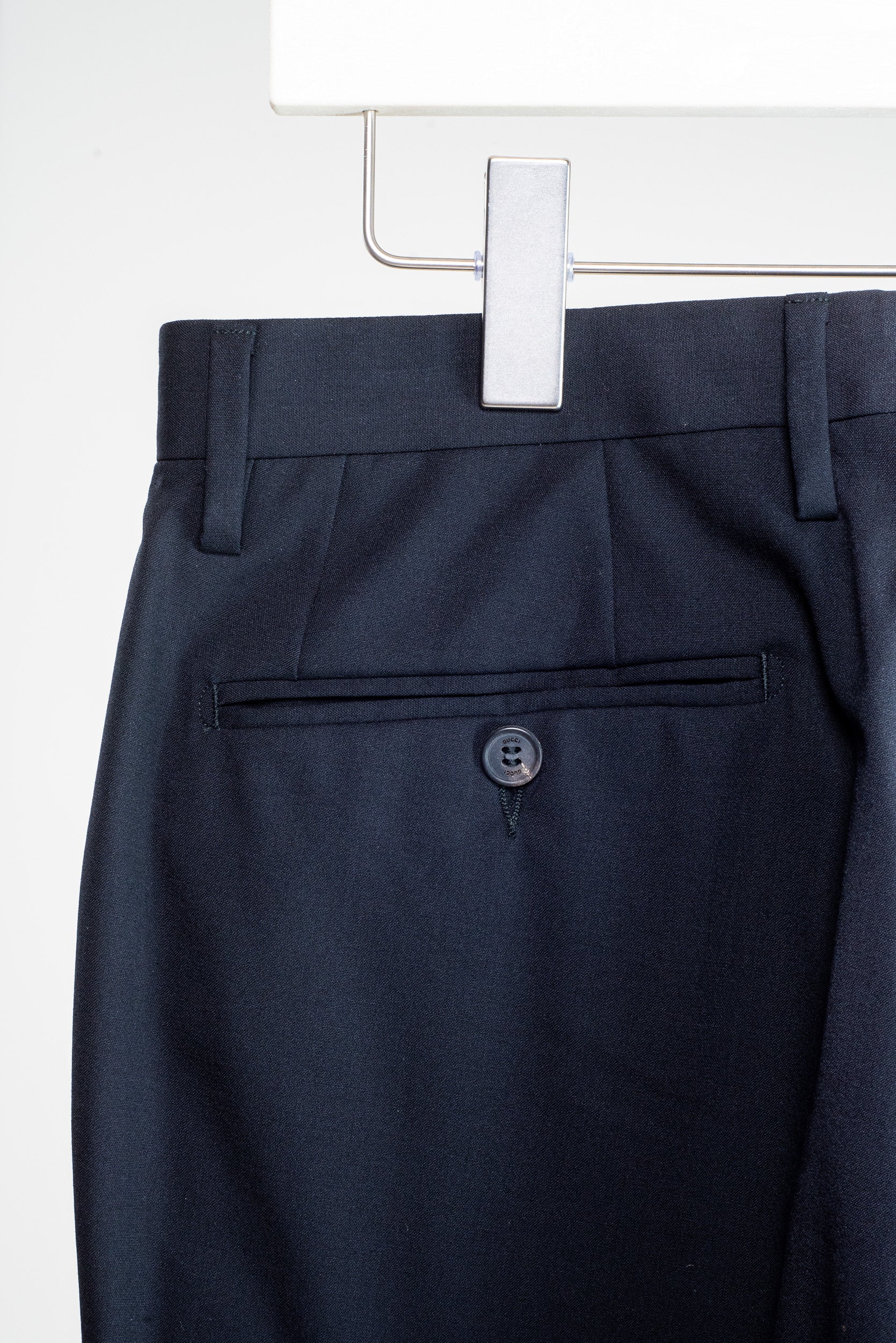 Close-up view of Gucci tailored pants with buttoned pockets – black, size S