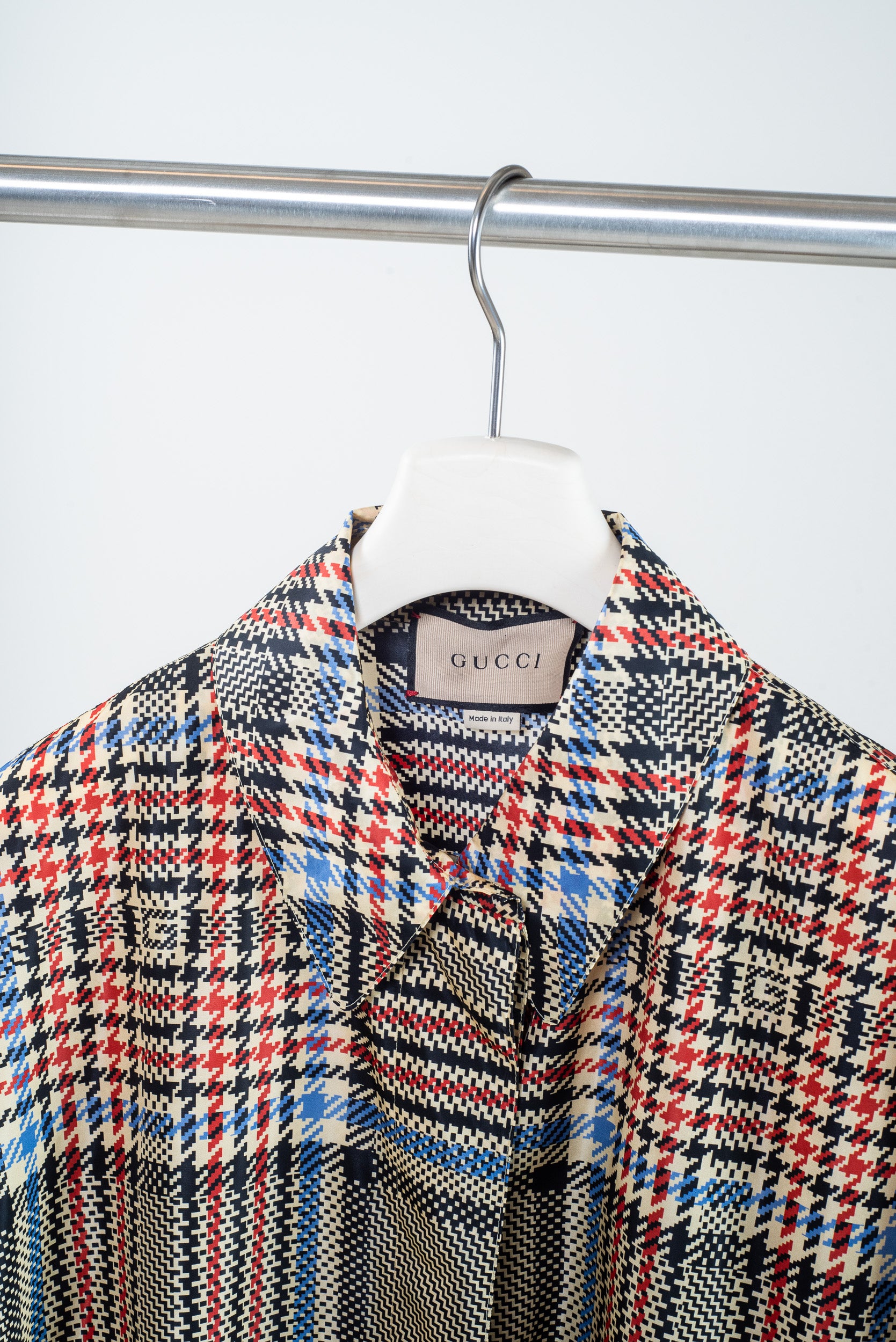 Close-up of GG monogram over plaid nylon fabric