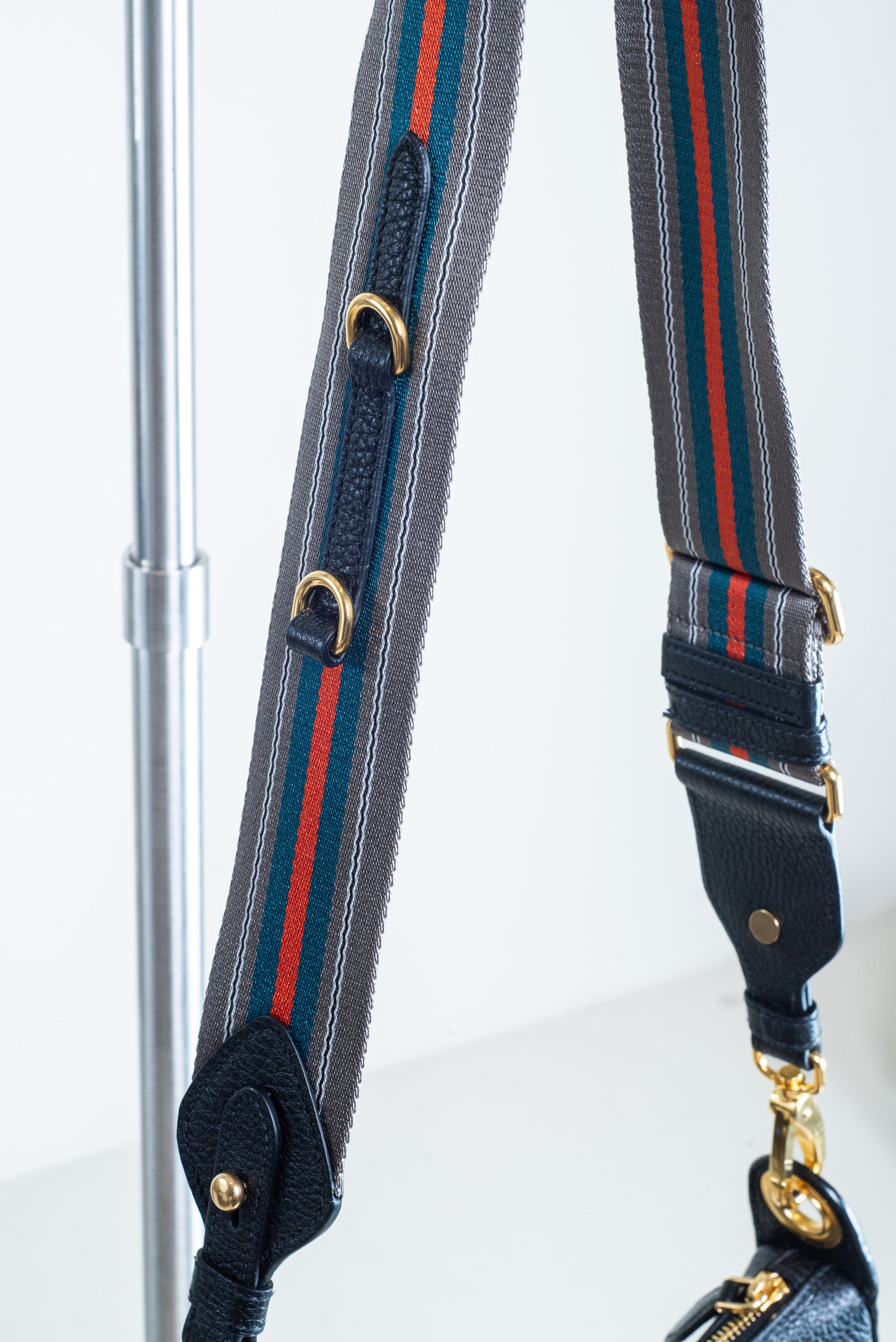 Detailed view of the Prada Black Vitello Leather Crossbody Bag’s adjustable/removable canvas strap